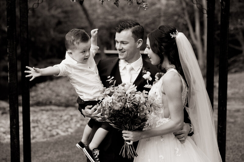 Bride and Groom with their son at the altar
