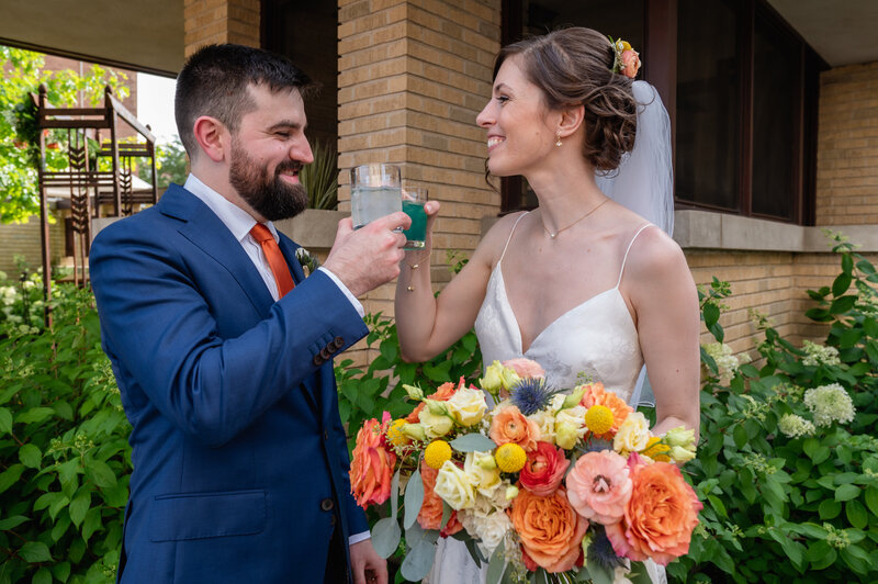 Bride and groom cheers with their signature cocktails in Chicago