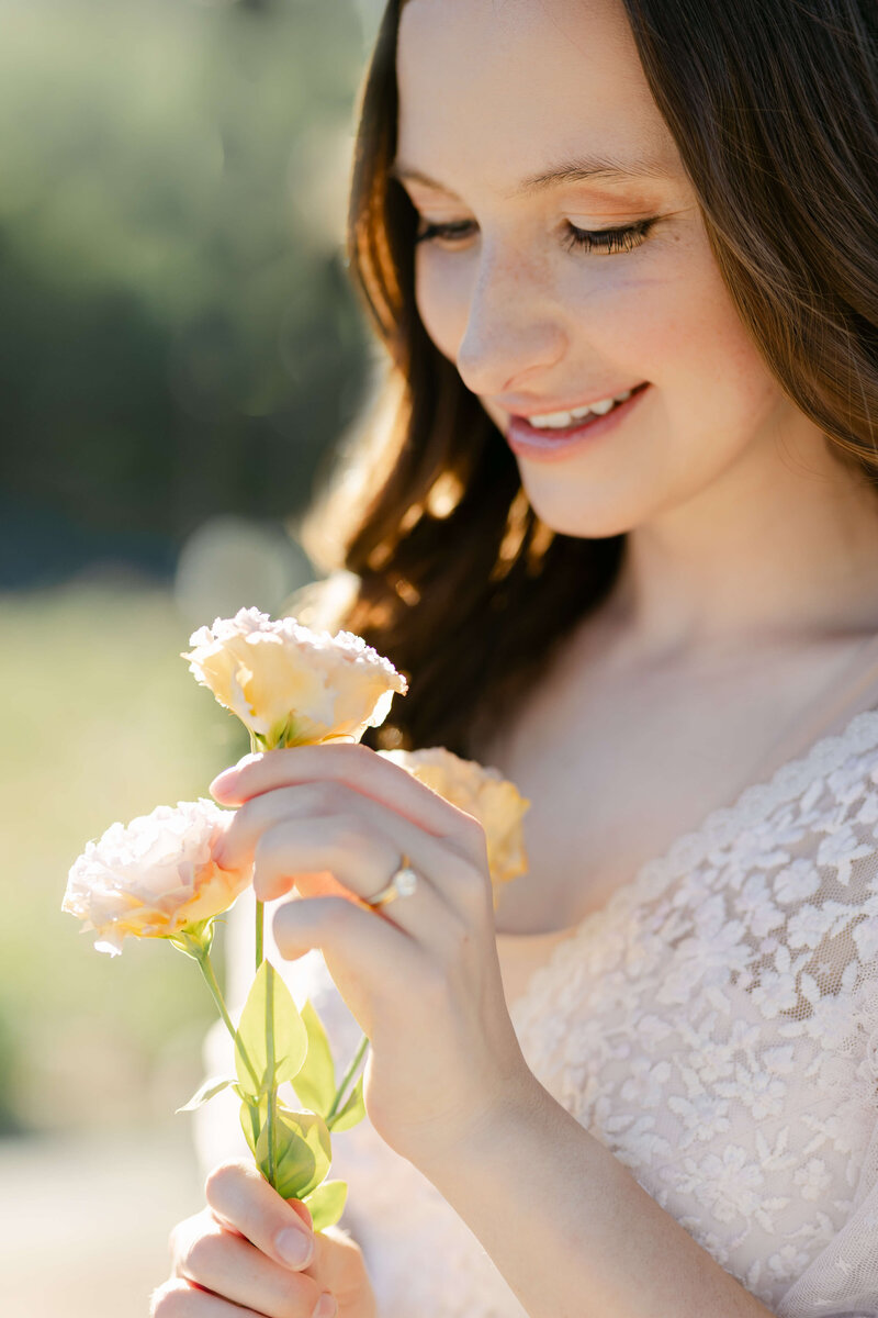 woman holding flowering branches and spinning