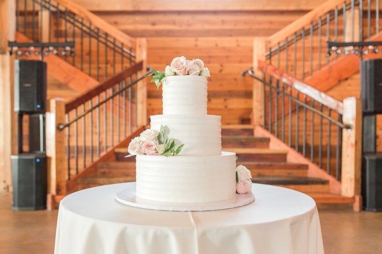three tiered wedding cake on a table