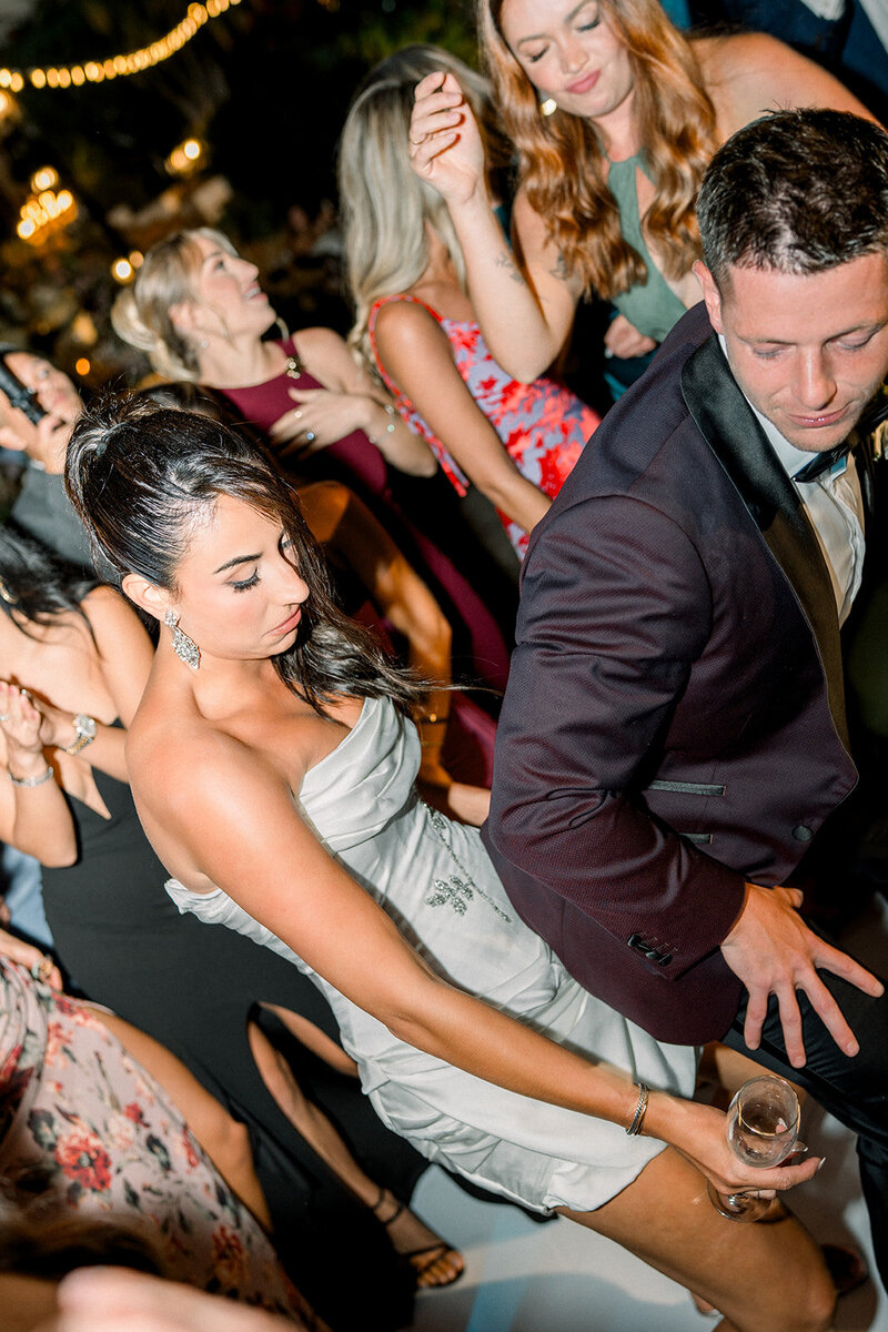 Bride dances joyfully during a luxury wedding reception in Los Angeles captured in a cinematic film photography style