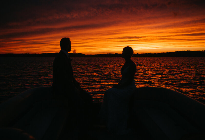 Bride & Groom silhouette in front of water sunset