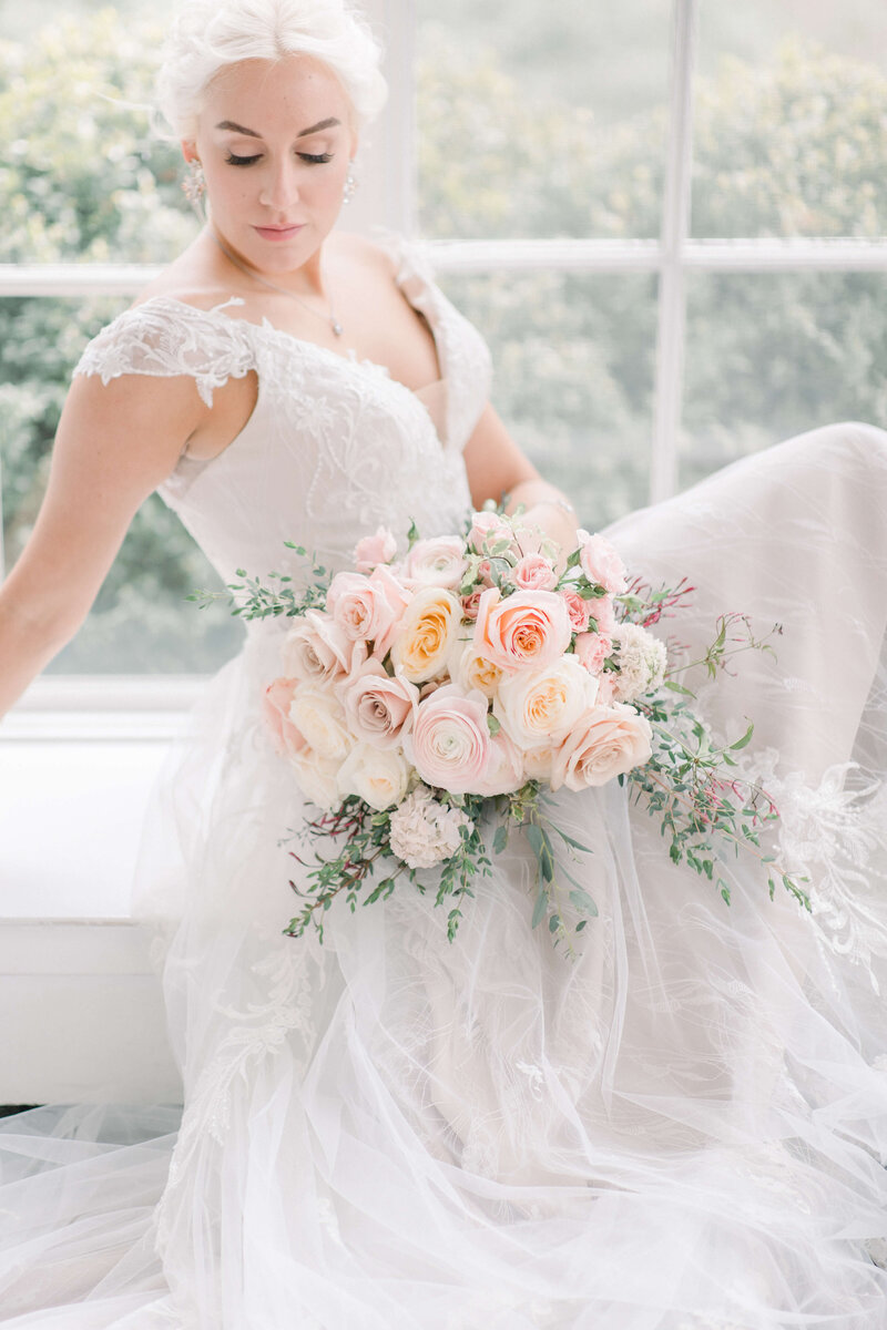 Bride at Tupper Manor holding bouquet styled by  Julie Riley Something Bleu Weddings