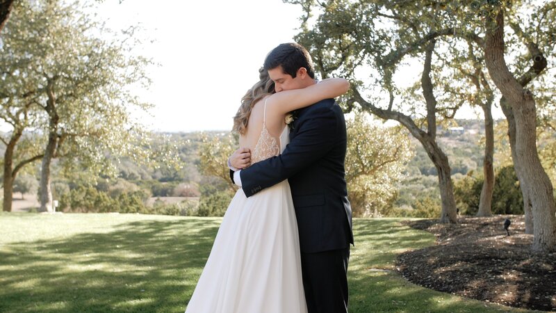 Bride and groom hold each other close in a Texas garden