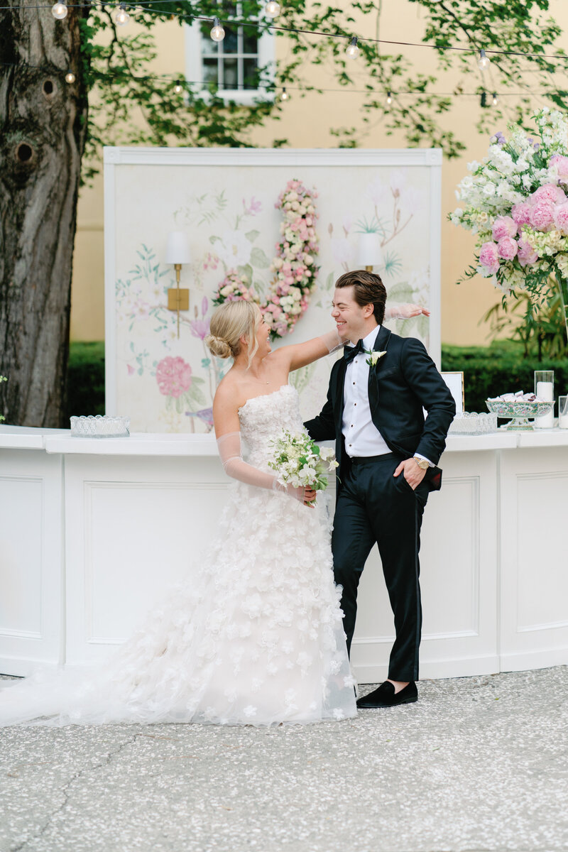 Pale pink jewel toned intimate Charleston fall elopement. Bride and groom under the lush greenery of live oak trees.