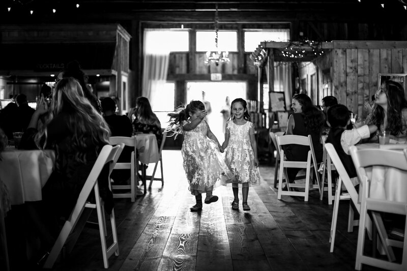 Little girls dance between tables at Port Farms wedding ceremony