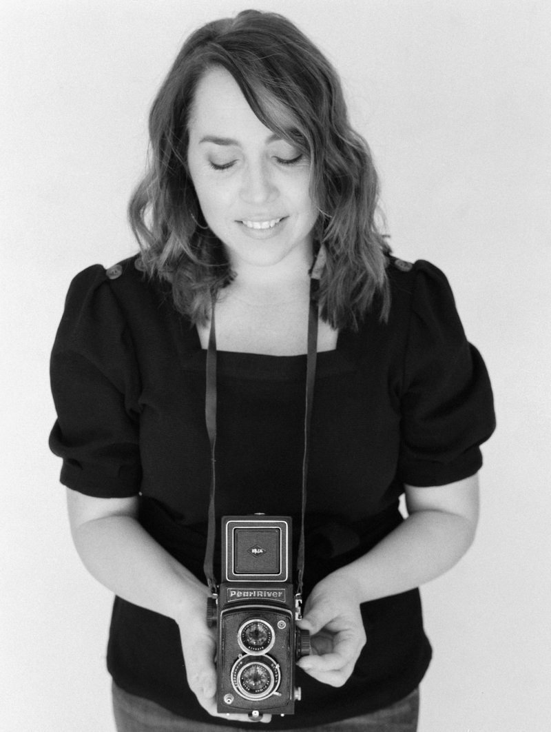 Photo of Natalie Bray holding vintage camera
