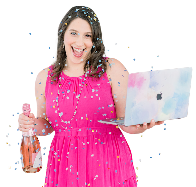Isabel Kateman in a pink dress holding laptop and champagne celebrating a website launch