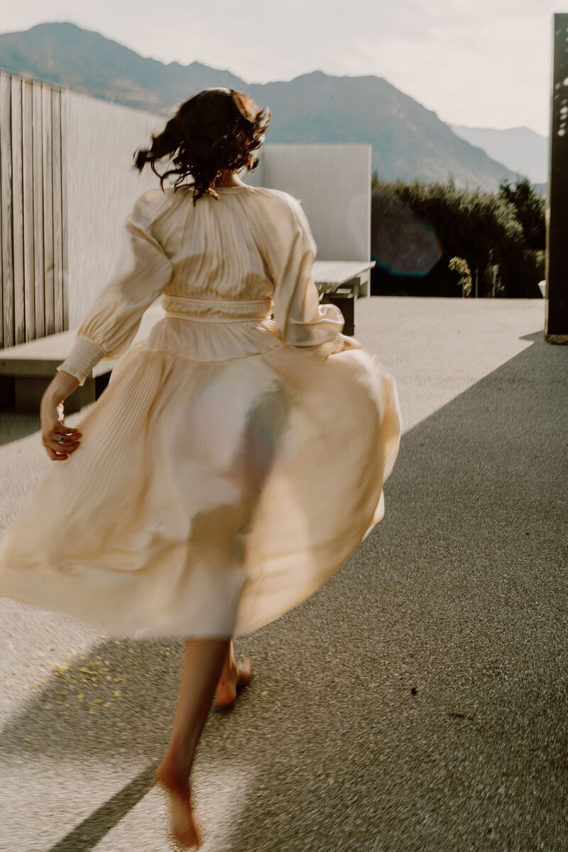 The Lovers Elopement Co - Wanaka Bridal - Bride walking with flowing dress