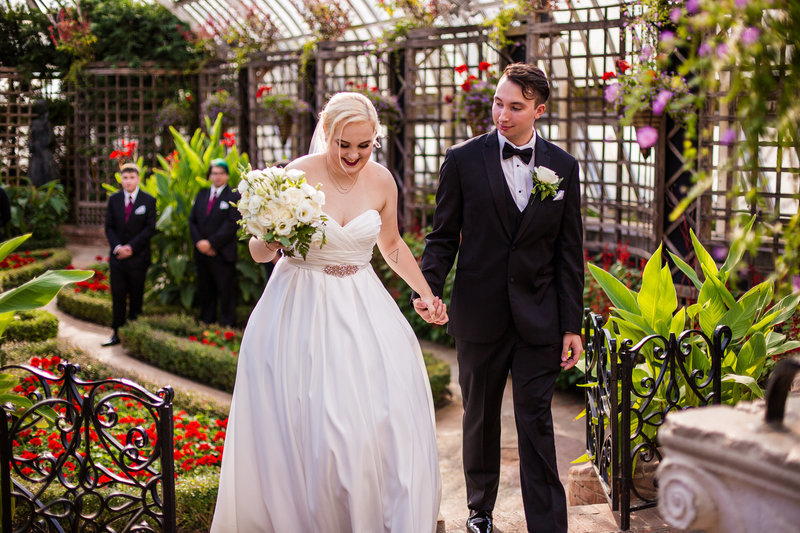 Recessional portrait of bride and groom at the end of their Phipps Conservatory wedding