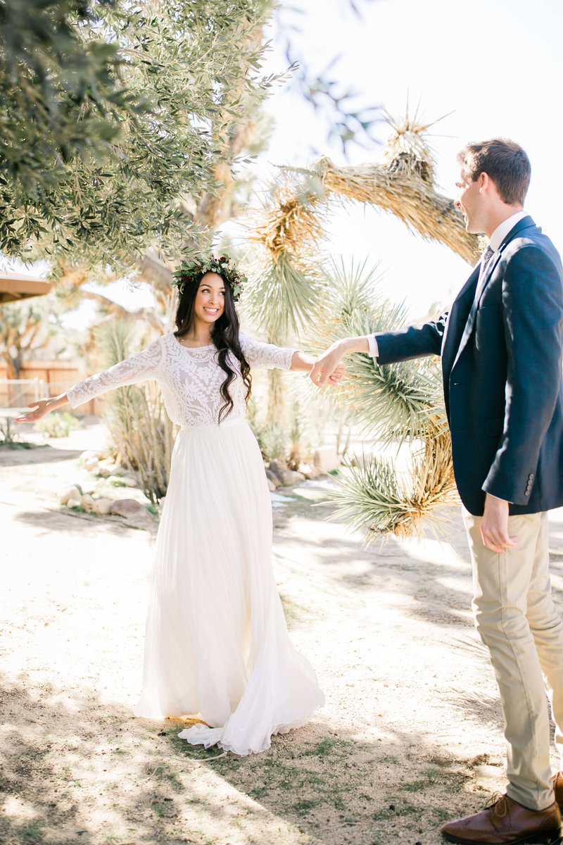 the happy bride and groom share a first look before their joshua tree adventure wedding