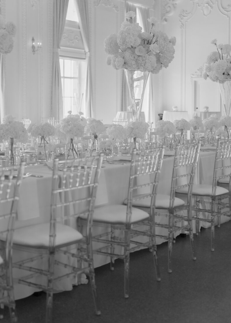 An iconic reception space filled with florals and glass chairs at the iconic Mayo Hotel in Tulsa Oklahoma