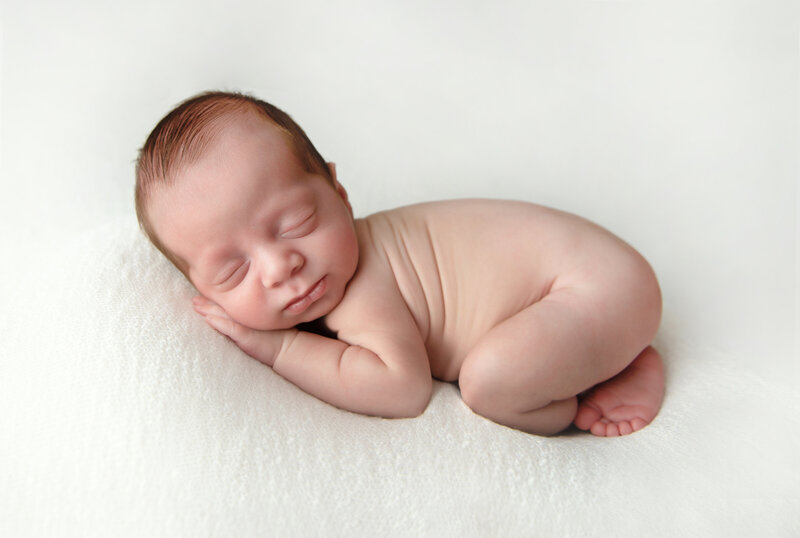 Sleeping newborn baby boy during nj newborn session.