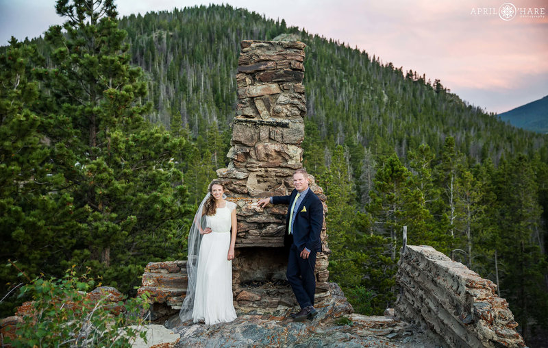Wedding photos with historic stone fireplace at YMCA of the Rockies at Sunset in Estes Park