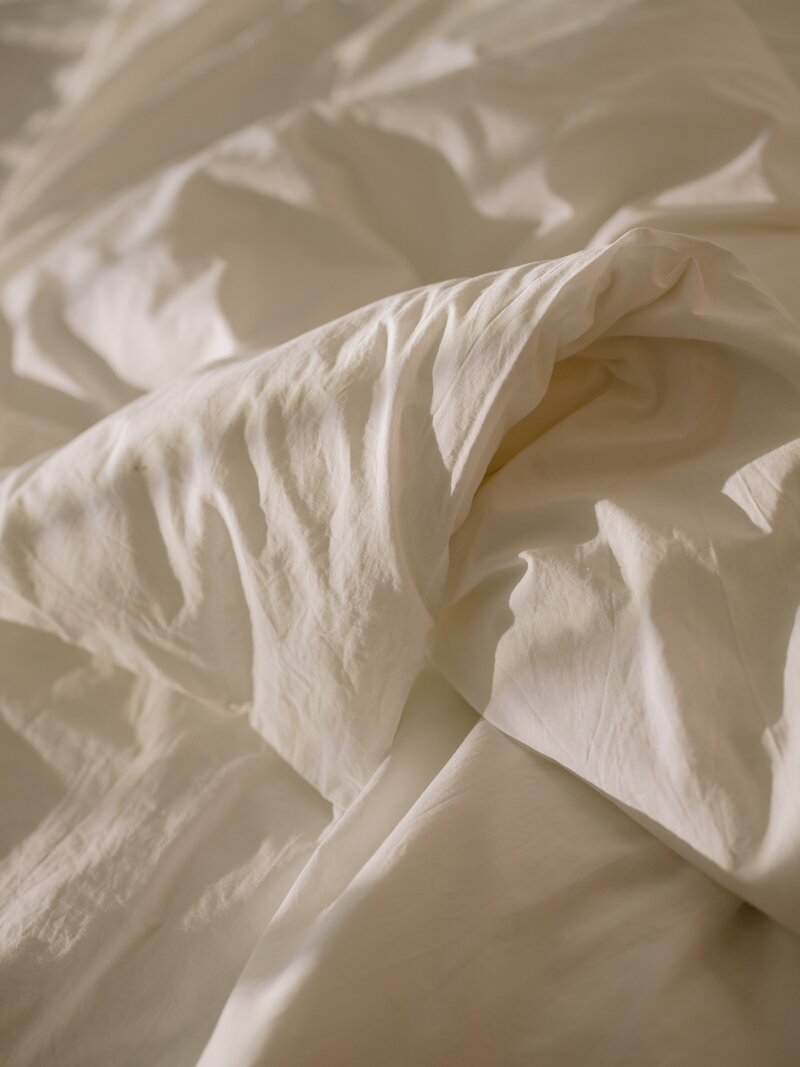 Folded sheets on a bed