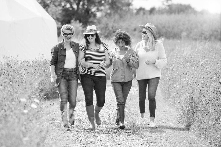 Four women walking confidently together