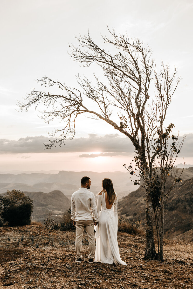 a-couple-in-white-dress-standing-in-view-of-the-mountain-2917382