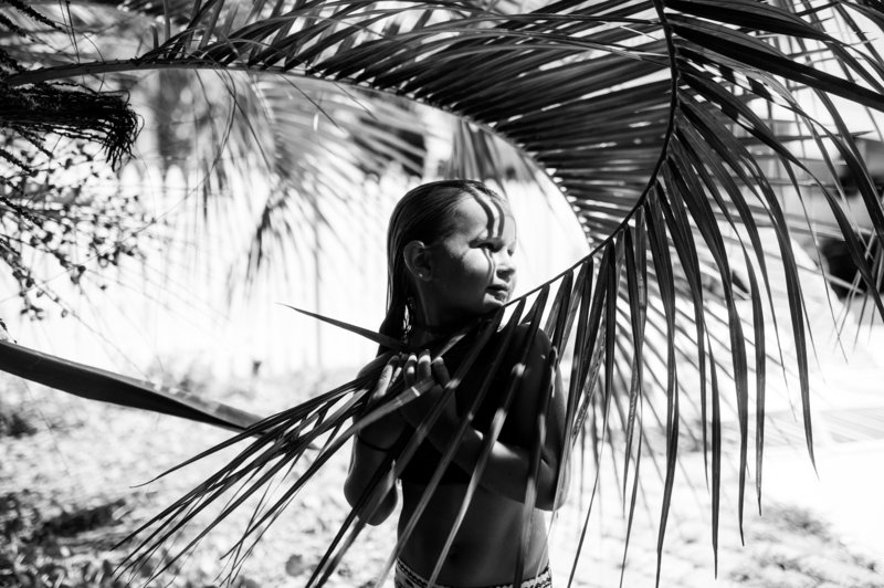 black and while image of a person with a palm tree
