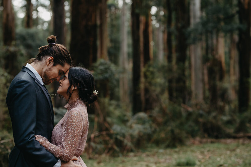 Intimate portrait of bride and groom in melbourne forest.