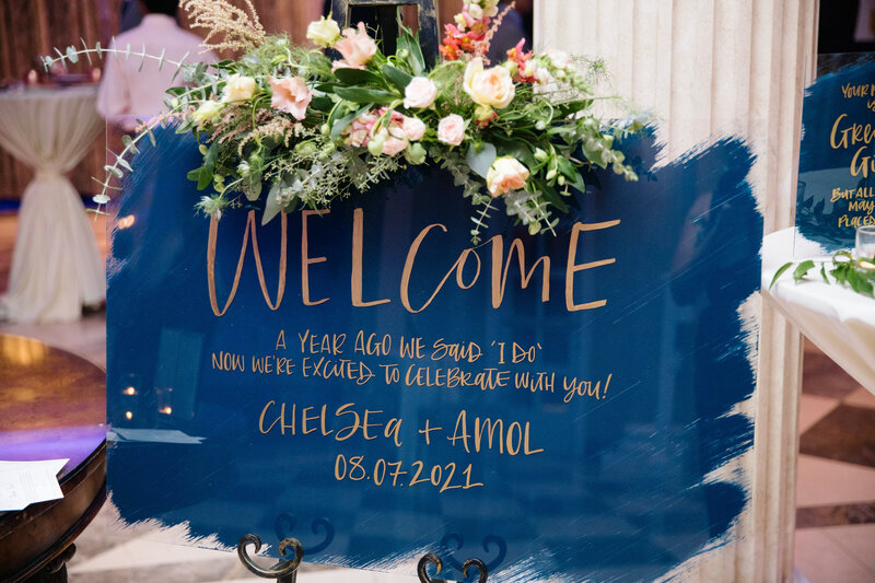 Gold calligraphy welcome sign with Navy blue  painted back