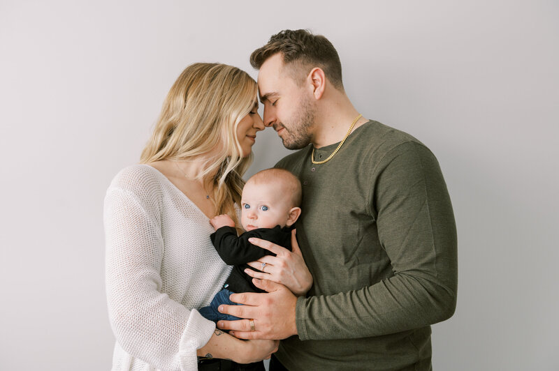 Couple embracing with baby boy being held