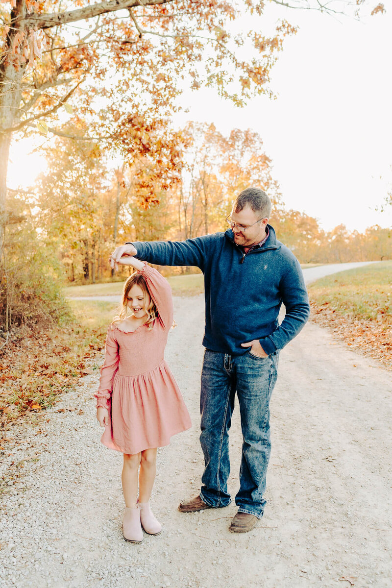 dad twirling daughter outside on southeast missouri farm