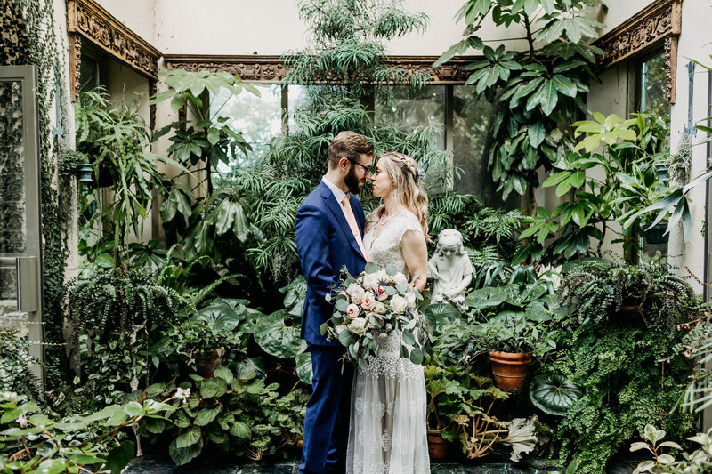 bride and groom in greenhouse