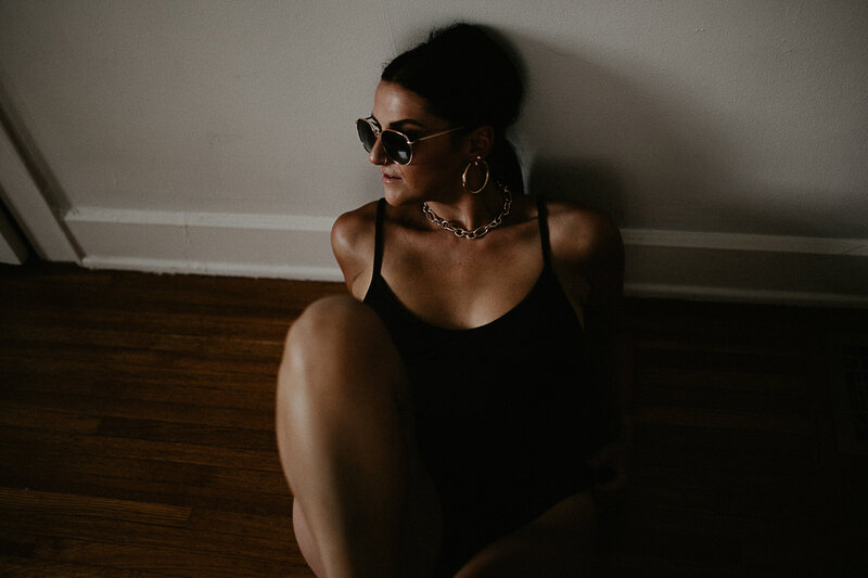 Woman in sunglasses during an Indianapolis boudoir session.