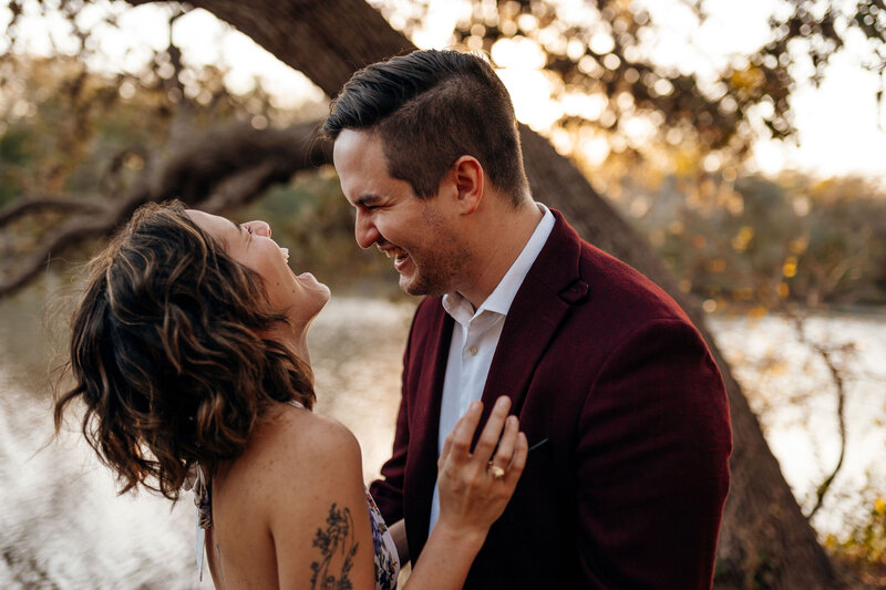 Couple laughs during their vow ceremony at Palmetto State Park near Austin, Texas