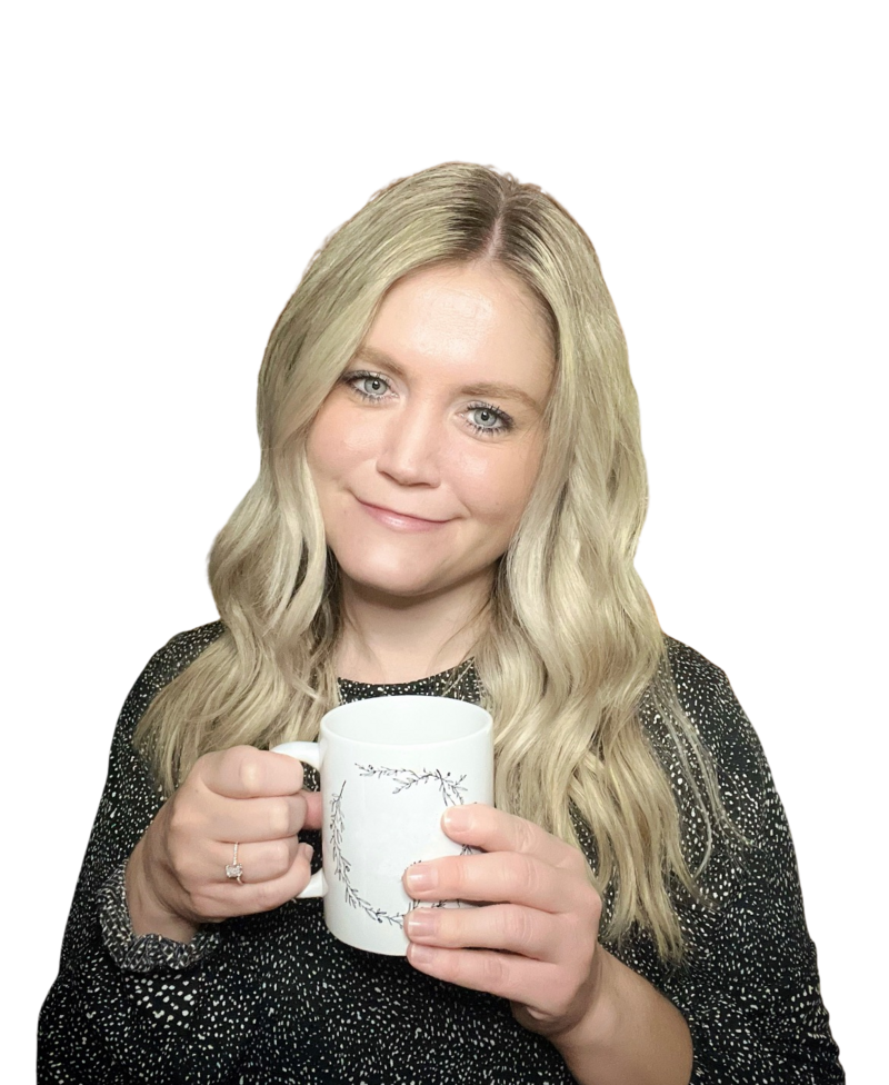 A dietitian named  Kerry Conlon holds a coffee mug featuring a unique vine drawing on its surface.