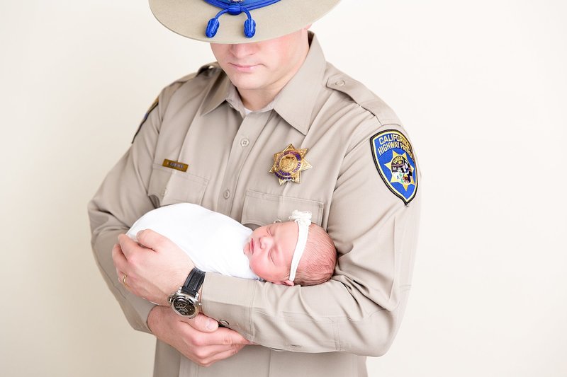 newborn with dad in uniform