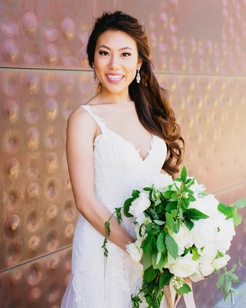 Portrait of Bride smiling holding boquet
