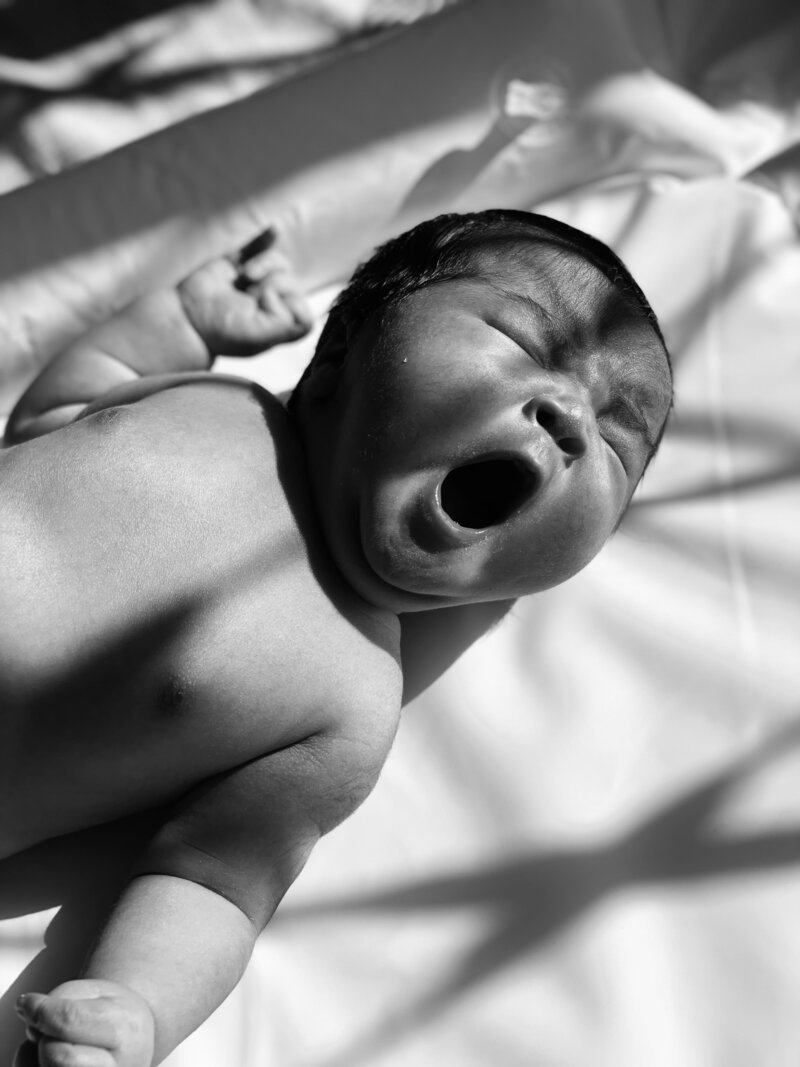 Baby yawning, in black and white