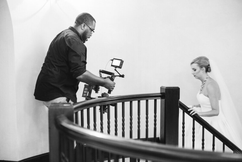 Wedding videographer filming bride walking up steps