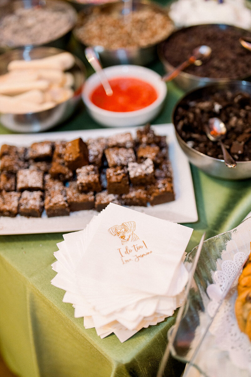 Brownies and custom-printed napkins displayed at a California wedding reception dessert bar captured by wedding photographer