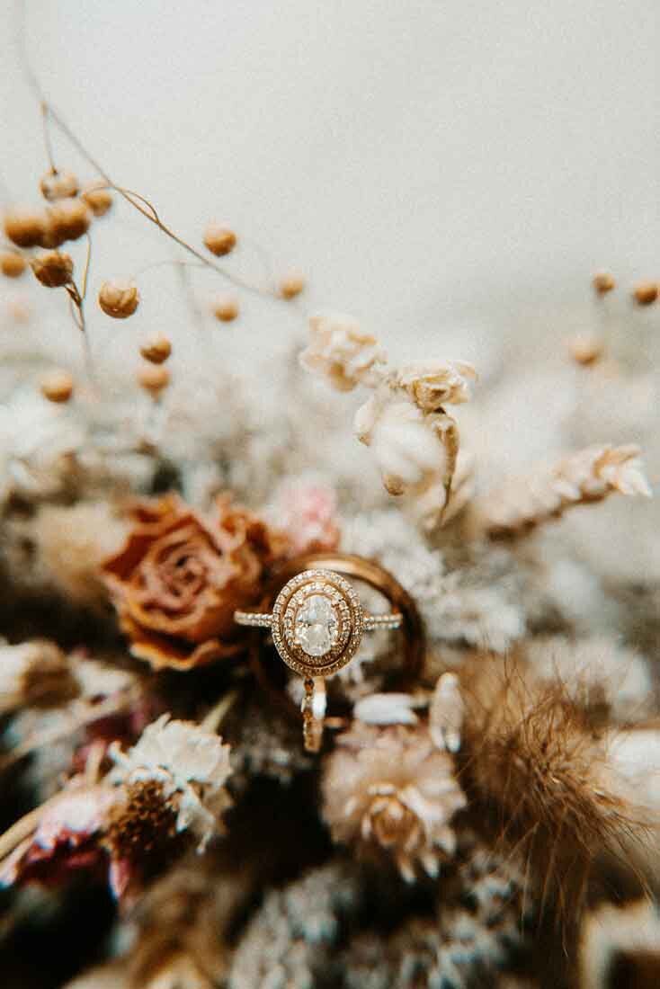 engagement-ring-close-up-in-dried-flowers-on-wedding-day-in-St-Louis-Missouri