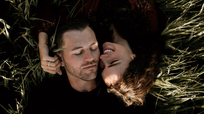 couple laying on the grass
