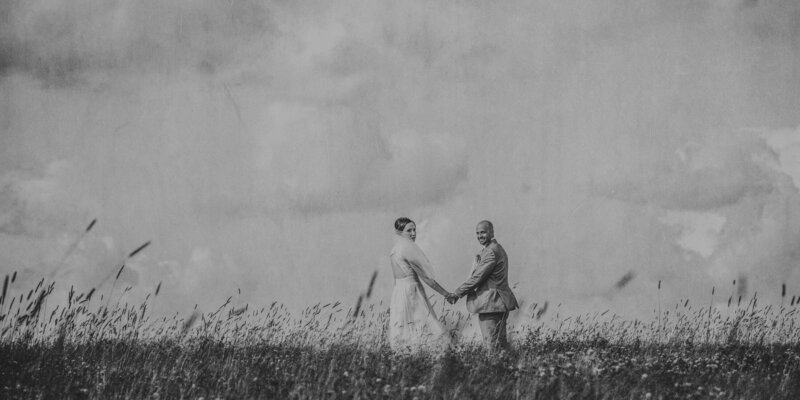 bride and groom in a wild field