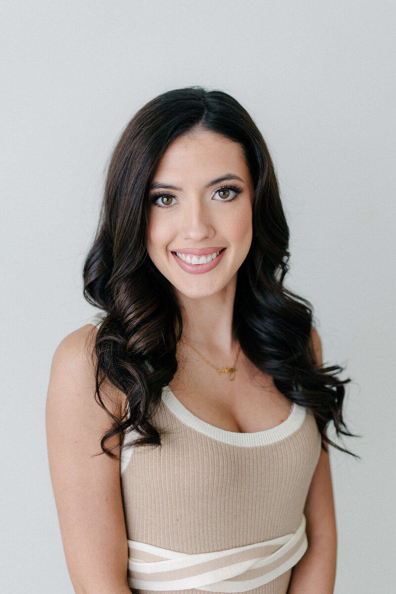 SoCo Dry Bar stylist creating the Hometown look with a smooth blowout and subtle bounce in College Station
