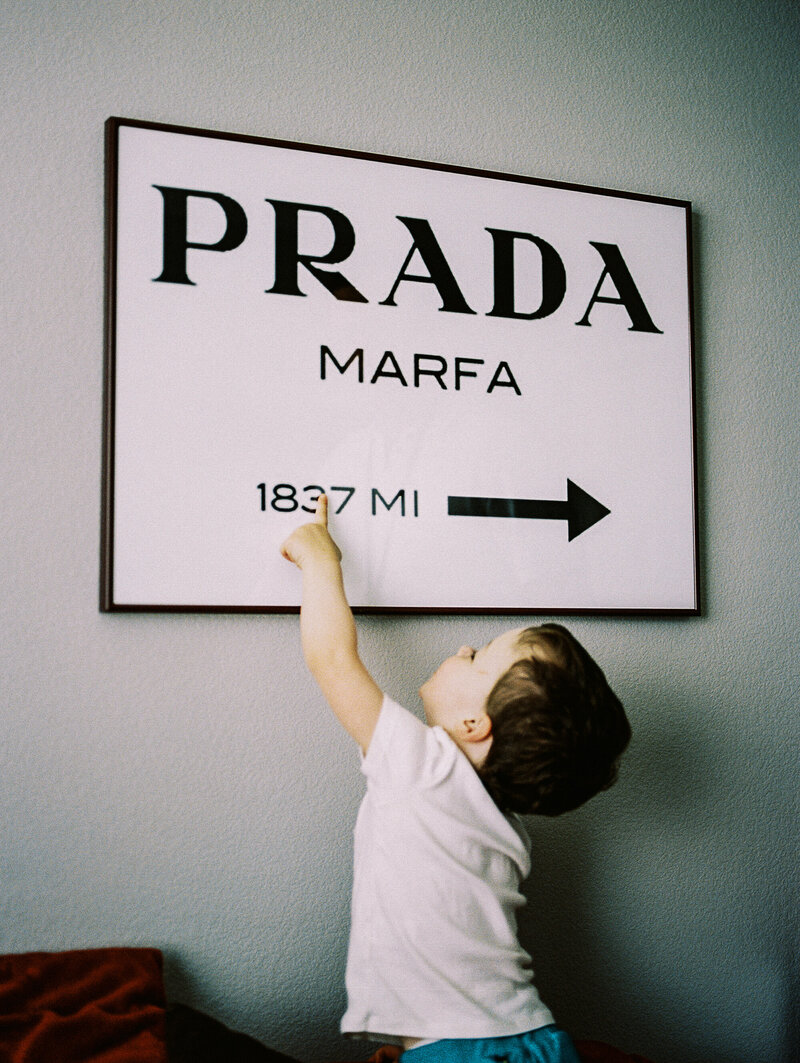 erie, co toddler points to a sign that says marfa