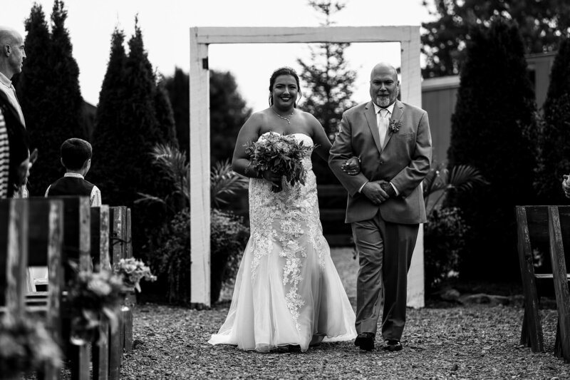 Bride walking down the aisle with her father at Port Farms wedding