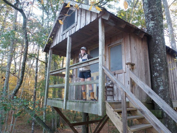 meredith ewenson standing on the porch of a treehouse on the edisto river in south carolina