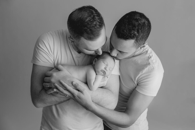 Grey Loft Studio - Bethany and Luc Barette - Wedding Photography Wedding Videography Ottawa - black and white photo LGBTQ+ couple holding newborn baby