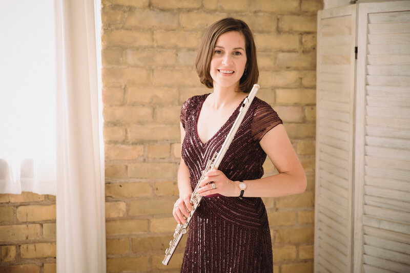 Flutist & Teaching Artist Sarah Weisbrod Standing with Flute in a Purple Dress