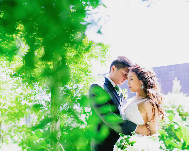 Candid Bride + Groom Intimate portrait framed by greenery