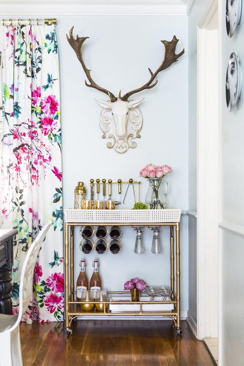 Dining Room with  styled brass and  canning bar cart, floral drapes