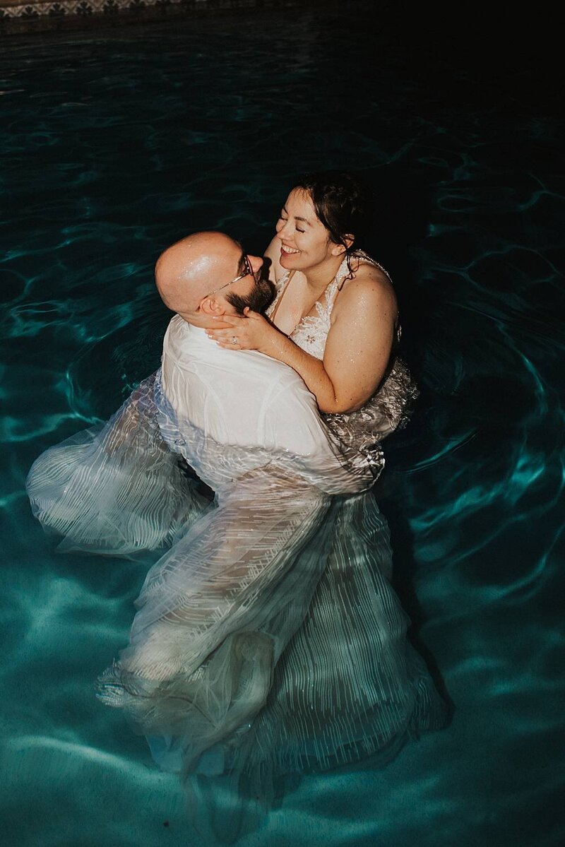 Couple popping champagne at night after their St. Augustine elopement