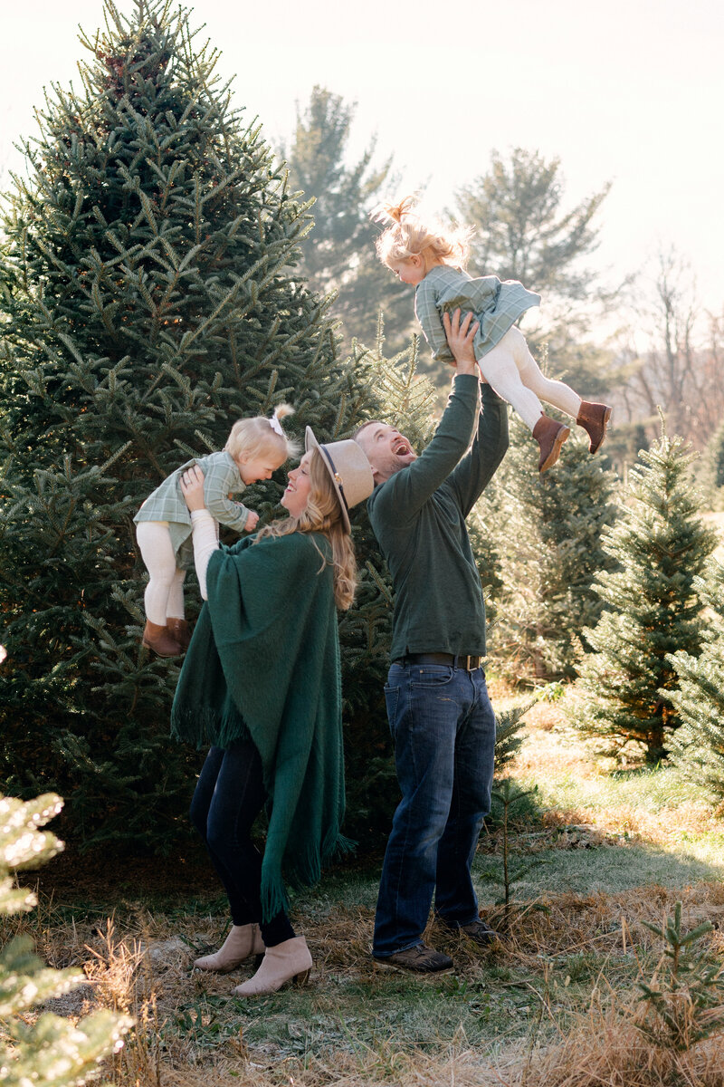 family photography session with Christmas trees