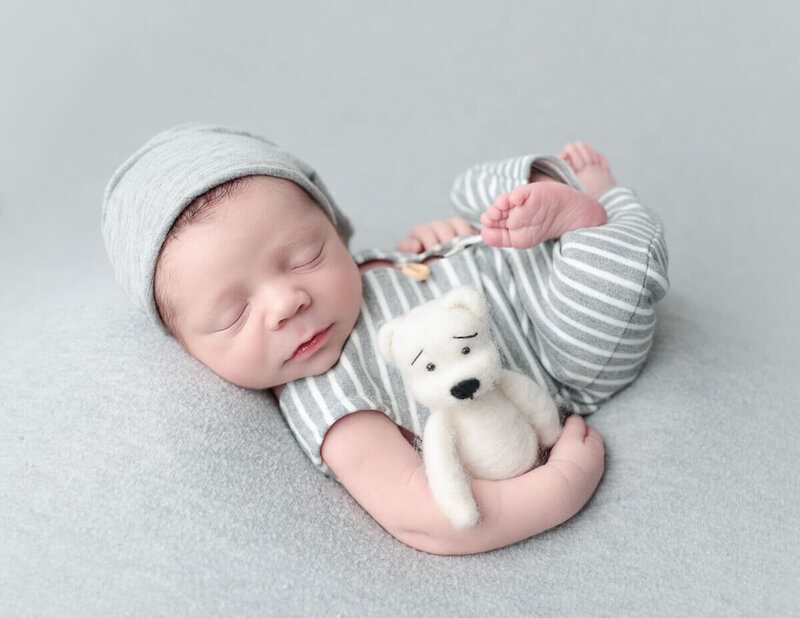 Capture precious moments with our expert newborn photography in Rochester, NY. Book your session today to photograph your baby with a favorite plush bear!