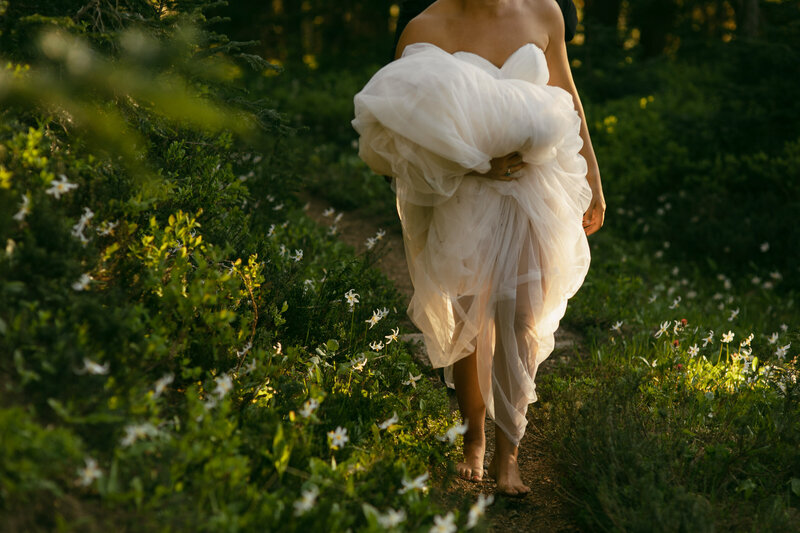 bride walking in wildflowers